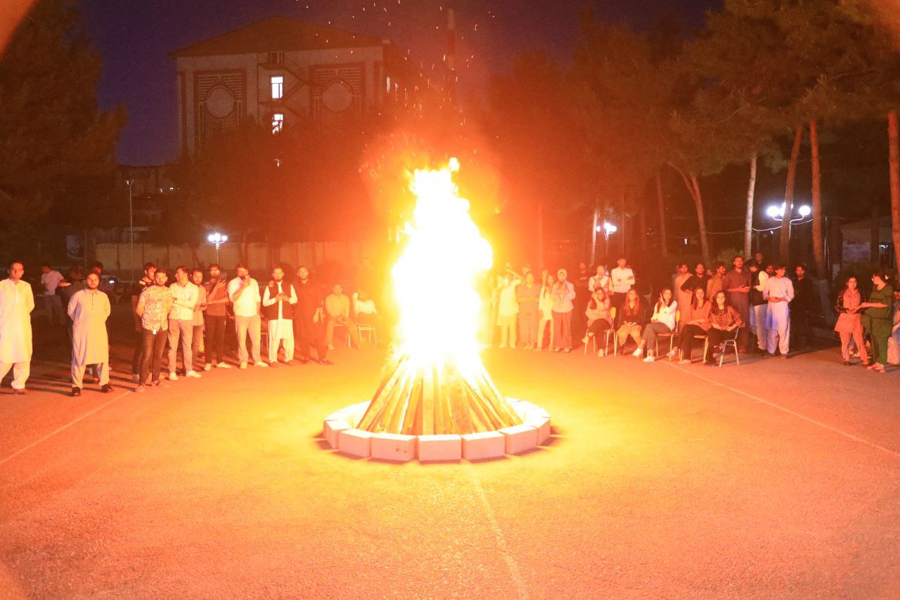INSTITUTE INTERNATIONAL STUDENTS GATHERED AROUND THE BIG FIRE